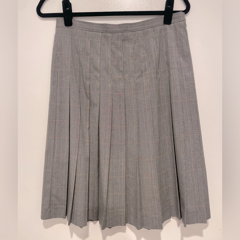 Pleated  grey skirt. Plaid with light pink/peach. Very flattering.